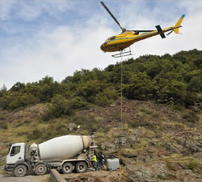 Concrete mixer truck feeding the skips brought to the site by helicopter. Well filling in the Chassezac gorges