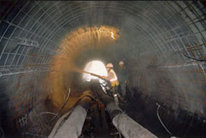 Relining of a corroded metal pipe with projected reinforced concrete and reinforced concrete