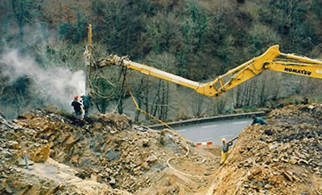 Drilling on major landslide on hillside , excavator on stable ground (16-m axle offset)