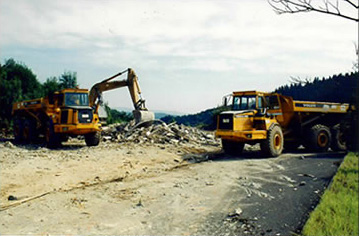 Excavator and dump trucks - rehabilitation of a mining site